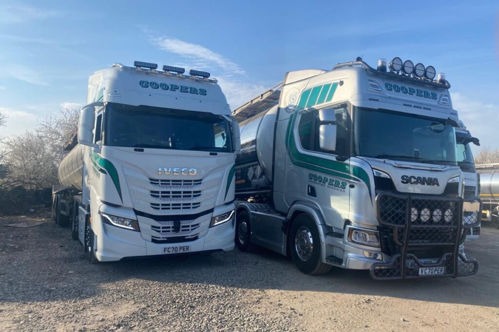 Two Coopers Transport lorries parked next to each other in the yard