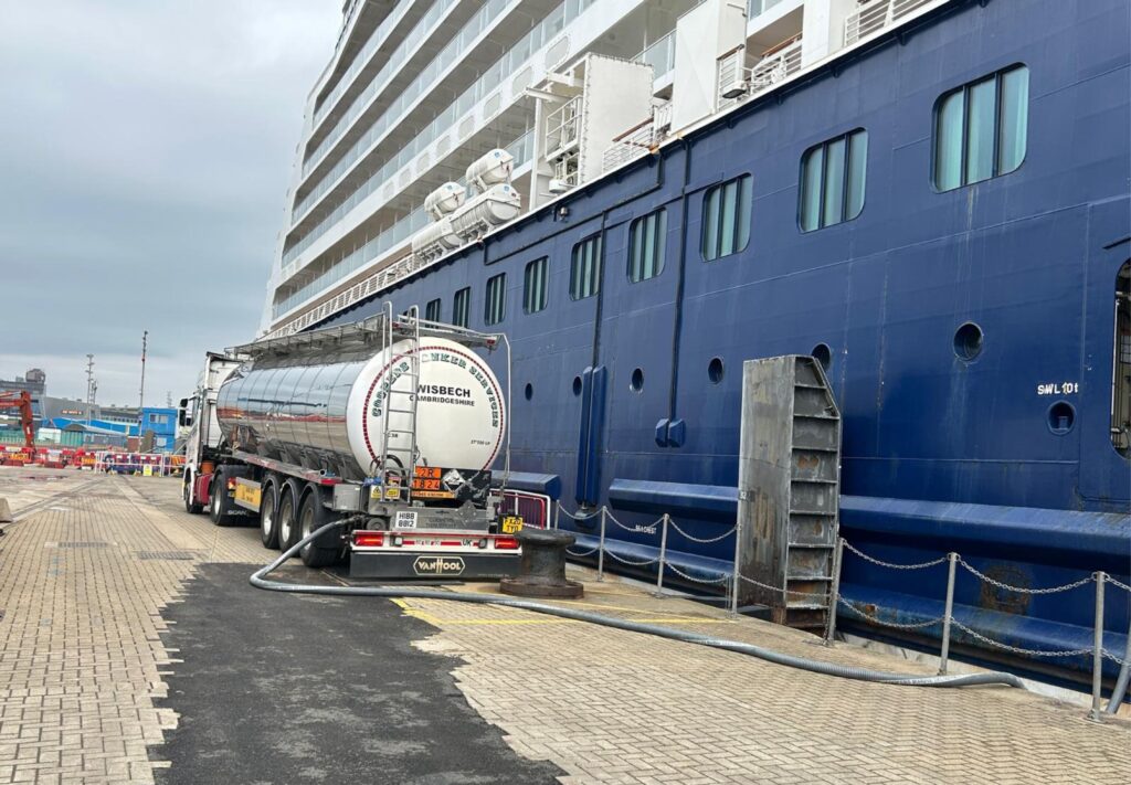 A tanker vehicle offloading into a cruise ship.